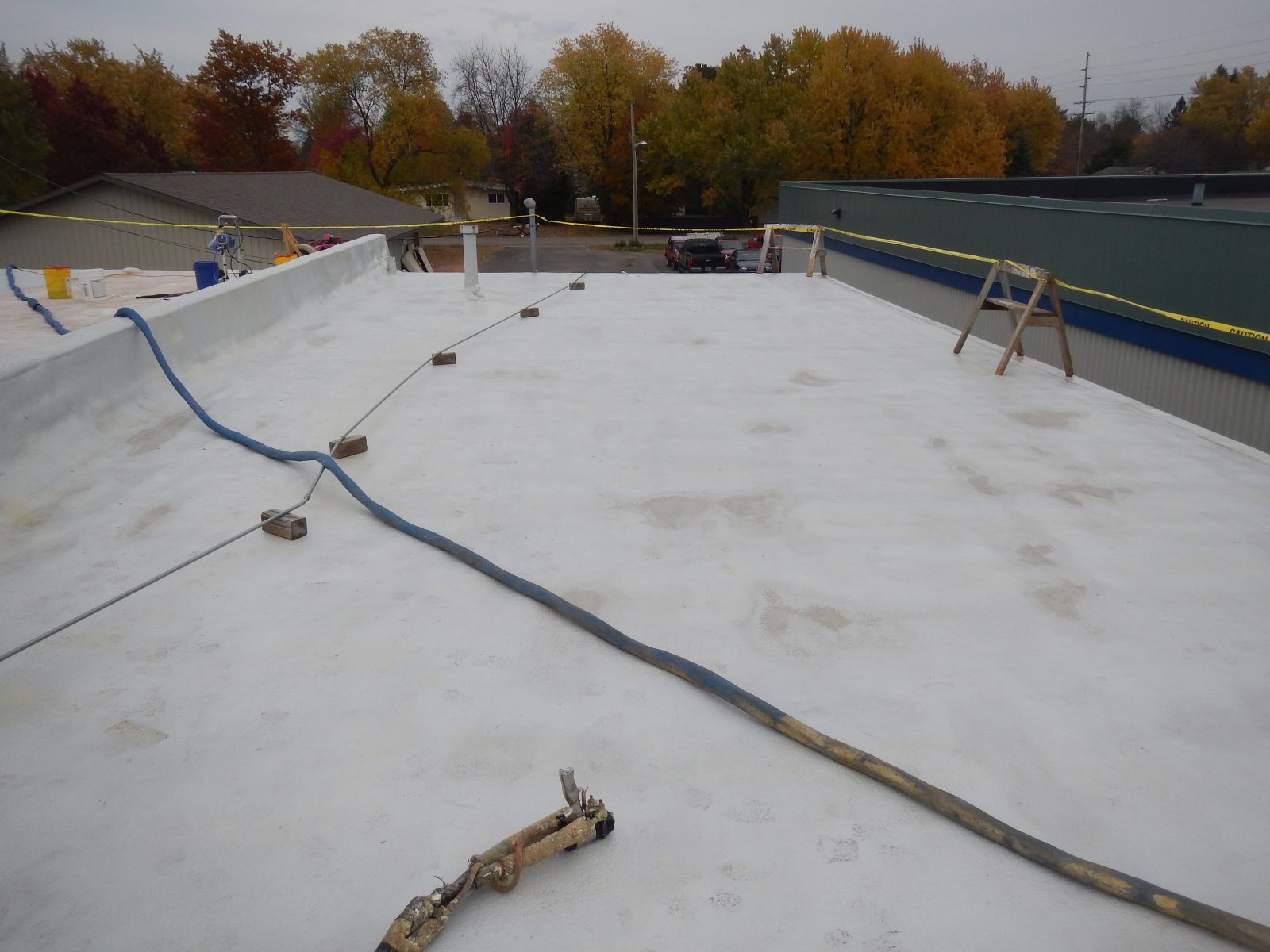 Metal roof coated with seamless polyurea waterproofing membrane